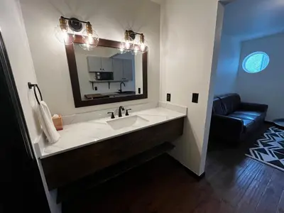 a bathroom with a large white sink and a mirror at Hotel Frisco in Frisco
