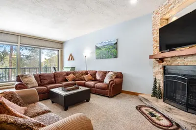 a living room with a couch and a fireplace at Pines Foxtail 2046 in Keystone