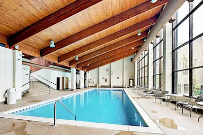 an indoor pool with a wooden ceiling and a swimming pool at Pines Foxtail 2046 in Keystone