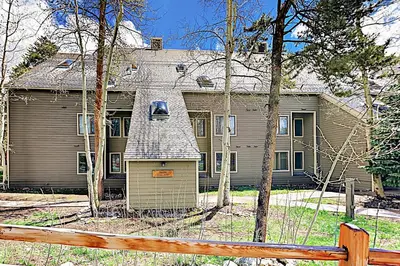 a large house with a fence in front of it at Pines Foxtail 2046 in Keystone