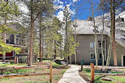 a house with a wooden fence in front of it at Pines Foxtail 2046 in Keystone