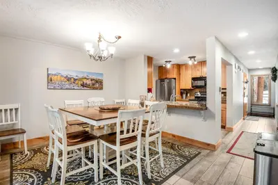 a kitchen and dining room with a table and chairs at Pines Foxtail 2046 in Keystone