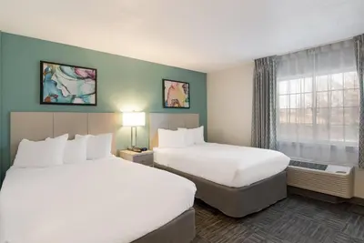 a hotel room with two beds and a window at MainStay Suites Denver Tech Center in Centennial