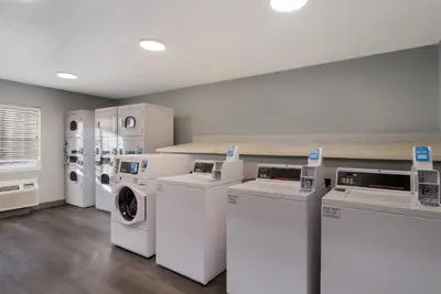 a laundry room with washers and dryers in it at MainStay Suites Denver Tech Center in Centennial