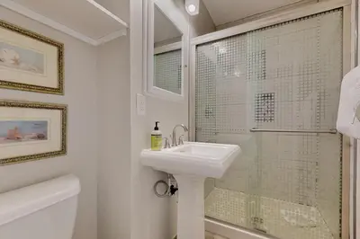 a white bathroom with a sink and a shower at Alpine Abode in Frisco