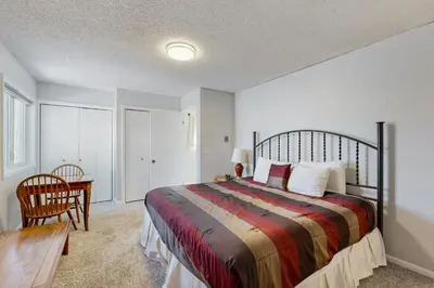 a bedroom with a bed and a desk and a table at Alpine Abode in Frisco