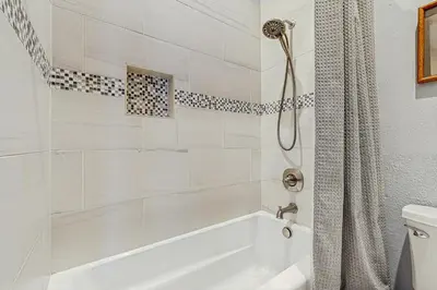 a white bathroom with a tub and a shower at Rivercrest 1 in Frisco