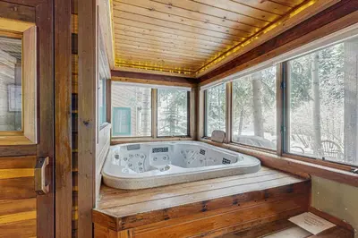 a jacuzzi tub in a room with windows at Rivercrest 1 in Frisco