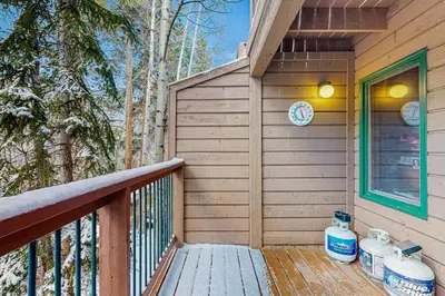 a porch of a cabin with a window and snow at Rivercrest 1 in Frisco