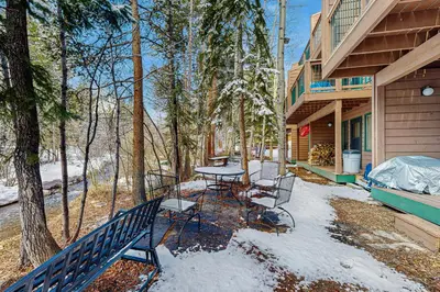 a patio with a table and chairs in the snow at Rivercrest 1 in Frisco