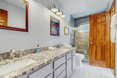 a bathroom with two sinks and a toilet at Rivercrest 1 in Frisco