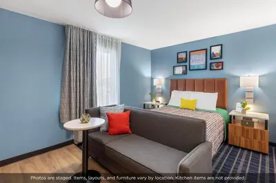 a hotel room with a bed and a couch at Uptown Suites Extended Stay Denver CO -Westminster in Westminster