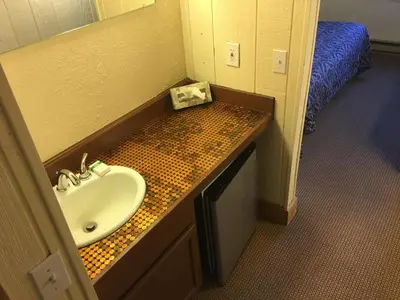 a bathroom with a sink and a counter with a sink at The Viking Lodge - Downtown Winter Park Colorado in Winter Park