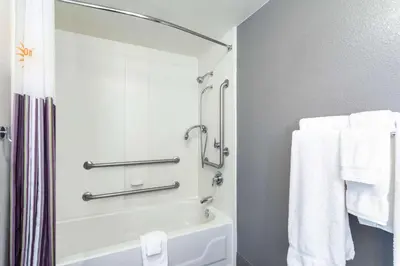 a bathroom with a bath tub and towels at La Quinta by Wyndham Denver Boulder - Louisville in Louisville