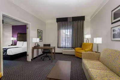 a hotel room with a bed and a couch at La Quinta by Wyndham Denver Boulder - Louisville in Louisville
