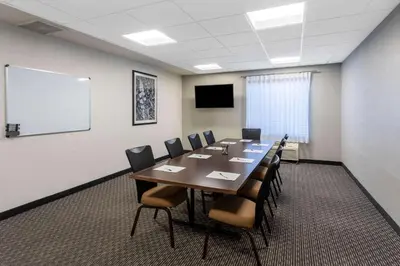 a conference room with a long table and chairs at La Quinta by Wyndham Denver Boulder - Louisville in Louisville