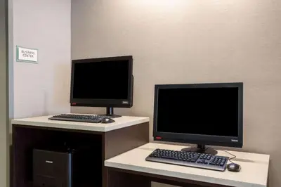 two computer monitors sitting on top of a desk at La Quinta by Wyndham Denver Boulder - Louisville in Louisville