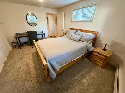a bedroom with a large bed and a table at Forest Feeling in Dillon