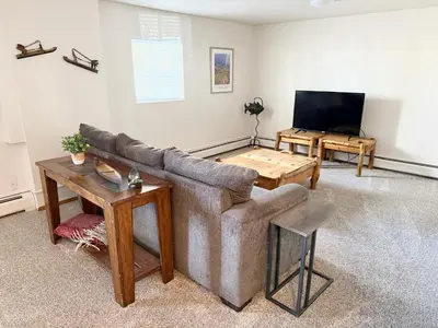 a living room with a couch and a flat screen tv at Forest Feeling in Dillon