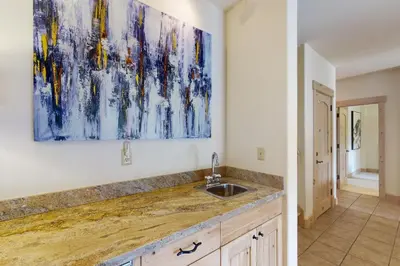 a kitchen with a sink and a painting on the wall at Easy Bend Elegance in Silverthorne