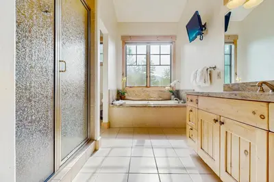 a bathroom with a shower and a tub at Easy Bend Elegance in Silverthorne