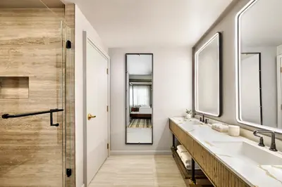 a bathroom with two sinks and a shower at Omni Interlocken Hotel in Broomfield