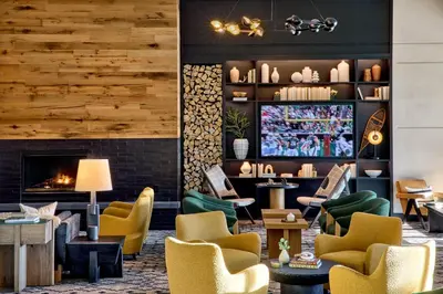 a lobby with chairs and a fireplace at Omni Interlocken Hotel in Broomfield