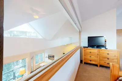 a attic room with a skylight and a television on a dresser at Gore Trail Getaway in Silverthorne