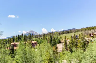 a building in the middle of a forest of trees at Gore Trail Getaway in Silverthorne