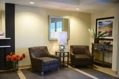 two chairs and a table in a waiting room at Candlewood Suites Denver Northeast - Brighton by IHG in Brighton