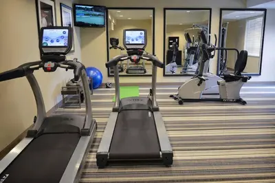 a gym with treadmills and elliptical machines at Candlewood Suites Denver Northeast - Brighton by IHG in Brighton