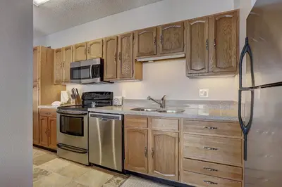 a kitchen with wooden cabinets and a stainless steel refrigerator at 303D Dillon Bay Condo Condo in Dillon