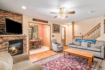 a living room with a fireplace and a tv at Elk Haven in Estes Park