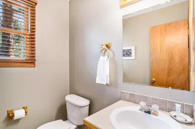 a bathroom with a sink and a toilet and a mirror at Elk Haven in Estes Park
