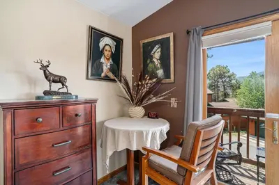 a dining room with a dresser and a table with a chair at Elk Haven in Estes Park