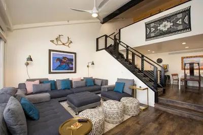 a living room with a couch and a staircase at Crestview Place Unit 507 in Winter Park