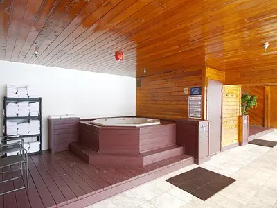 a jacuzzi tub in a room with a wooden wall at Crestview Place Unit 507 in Winter Park