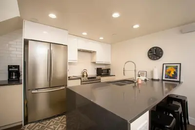 a large kitchen with a stainless steel refrigerator at Crestview Place Unit 507 in Winter Park