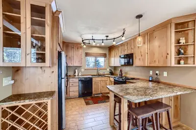 a kitchen with wooden cabinets and a large island at Mountainside 753 Home in Frisco