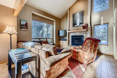 a living room with a couch and a fireplace at Mountainside 753 Home in Frisco
