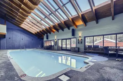 a large swimming pool in a building with a ceiling at Mountainside 753 Home in Frisco