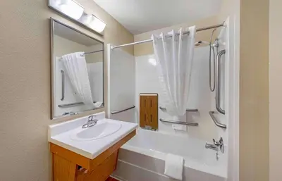 a white bathroom with a sink and a shower at Extended Stay America Suites - Denver - Airport in Aurora