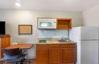 a kitchen with a sink and a white refrigerator at Extended Stay America Suites - Denver - Airport in Aurora