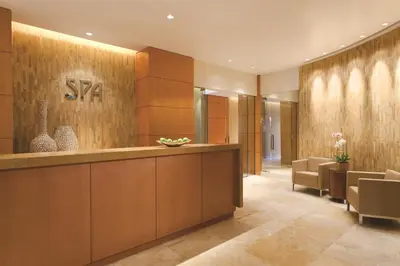 a hotel lobby with a reception desk and chairs at Four Seasons Hotel Denver in Denver