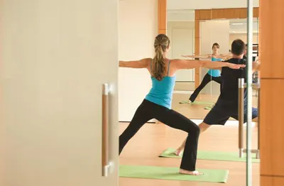 a group of people doing yoga in a yoga class at Four Seasons Hotel Denver in Denver