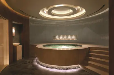 a bathroom with a large tub with a circular ceiling at Four Seasons Hotel Denver in Denver