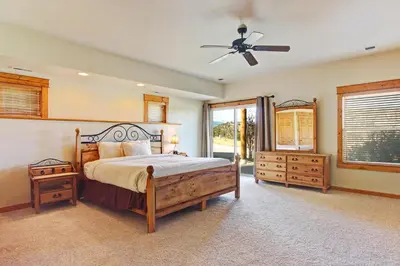 a bedroom with a bed and a ceiling fan at Mount Acoma 38 Condo in Estes Park