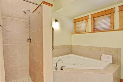 a bathroom with a bath tub and a shower at Mount Acoma 38 Condo in Estes Park