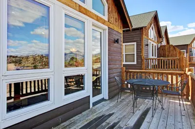 a patio with a table and chairs on a deck at Mount Acoma 38 Condo in Estes Park