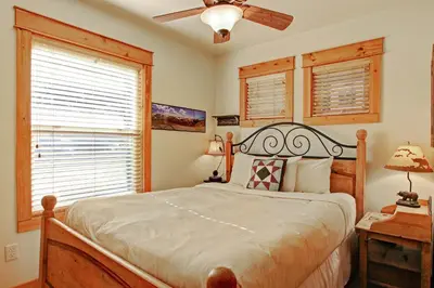 a bedroom with a bed and a ceiling fan at Mount Acoma 38 Condo in Estes Park